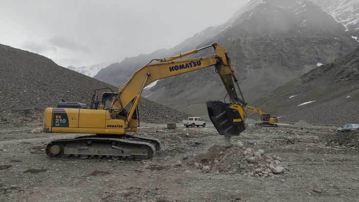 The MB Crusher Buckets crushing rocks to produce aggregates for a high altitude road project