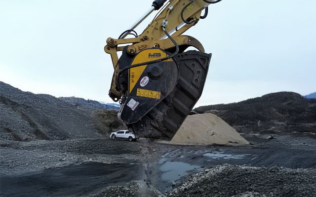 MB Crusher BF90.3 jaw crusher bucket in action on an aggregate production and recycling site in Canada, operated by Northern Constructors Ltd.