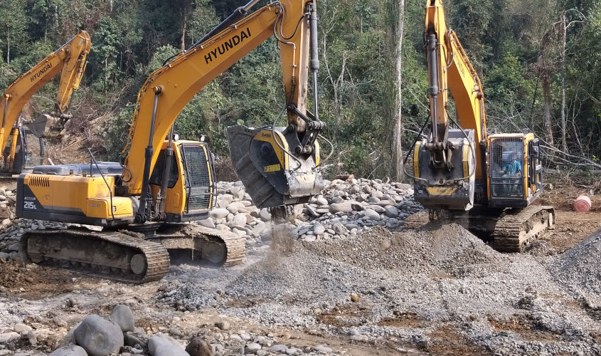 Two BF90.3 crusher buckets, installed on a Hyundai 215LC, are crushing river stone to produce aggregate for road work. Two BF90.3 crusher buckets, installed on a Hyundai 215LC, are crushing river stone to produce aggregate for road work.