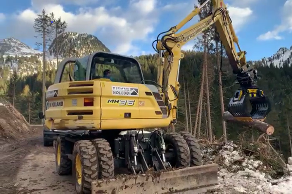 An MB-G900 sorting grapple clearing the roads of fallen tree trunks and debris after a storm.